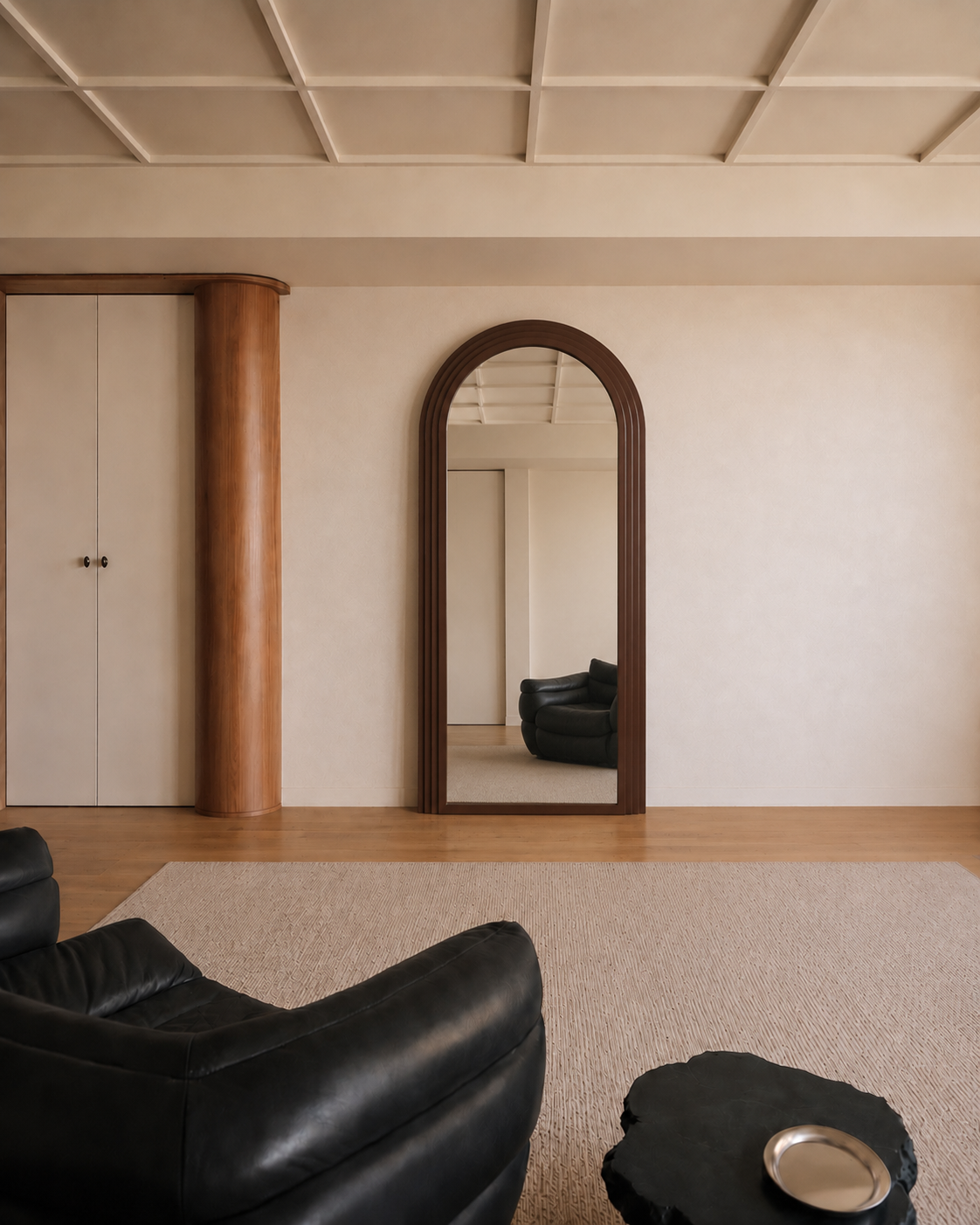 Cassian arched floor mirror in walnut, front view in a living room