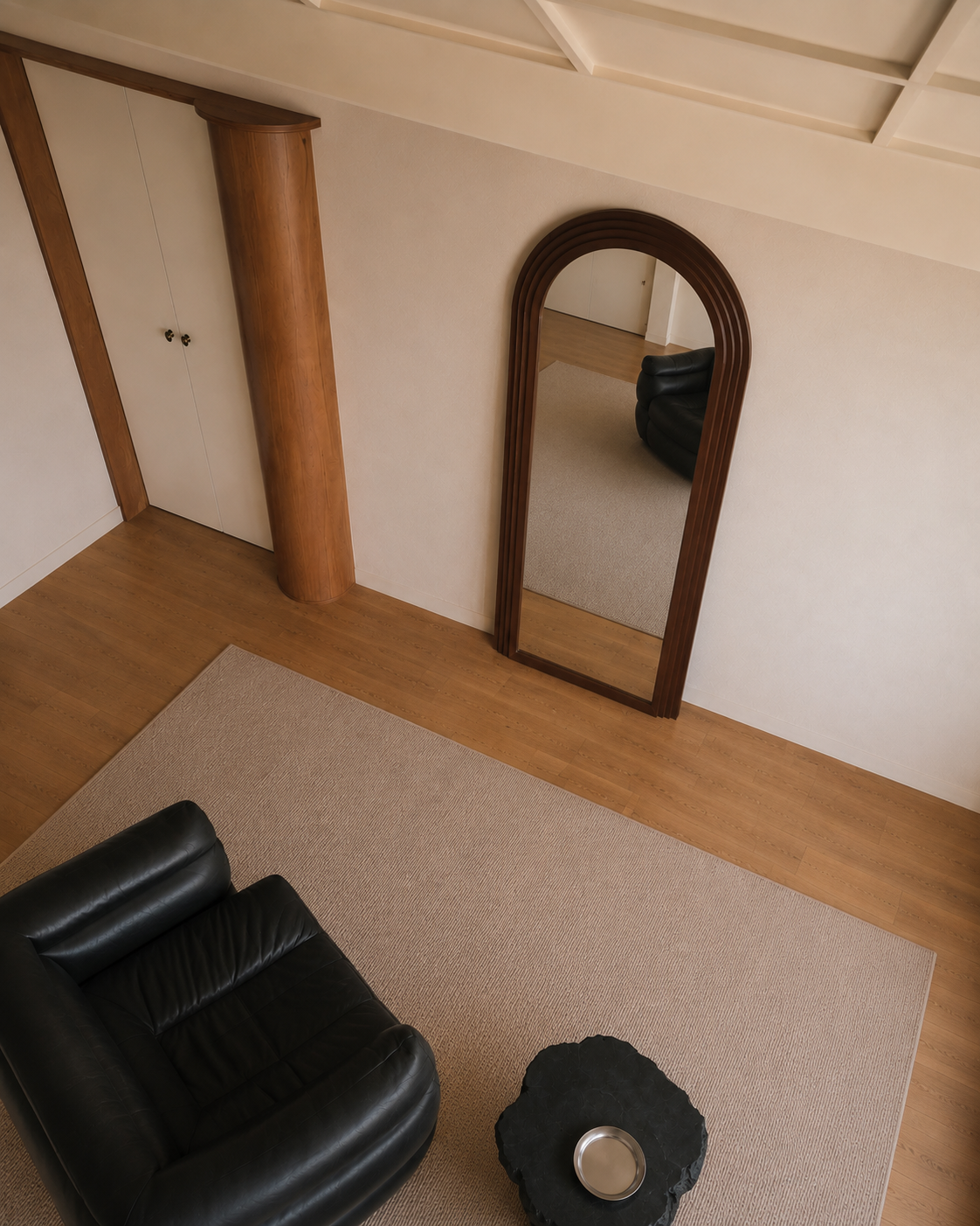 Cassian arched floor mirror leaning against the wall, viewed from above