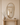 Ruve mirror above a pale wood console with a ceramic vase in an entryway